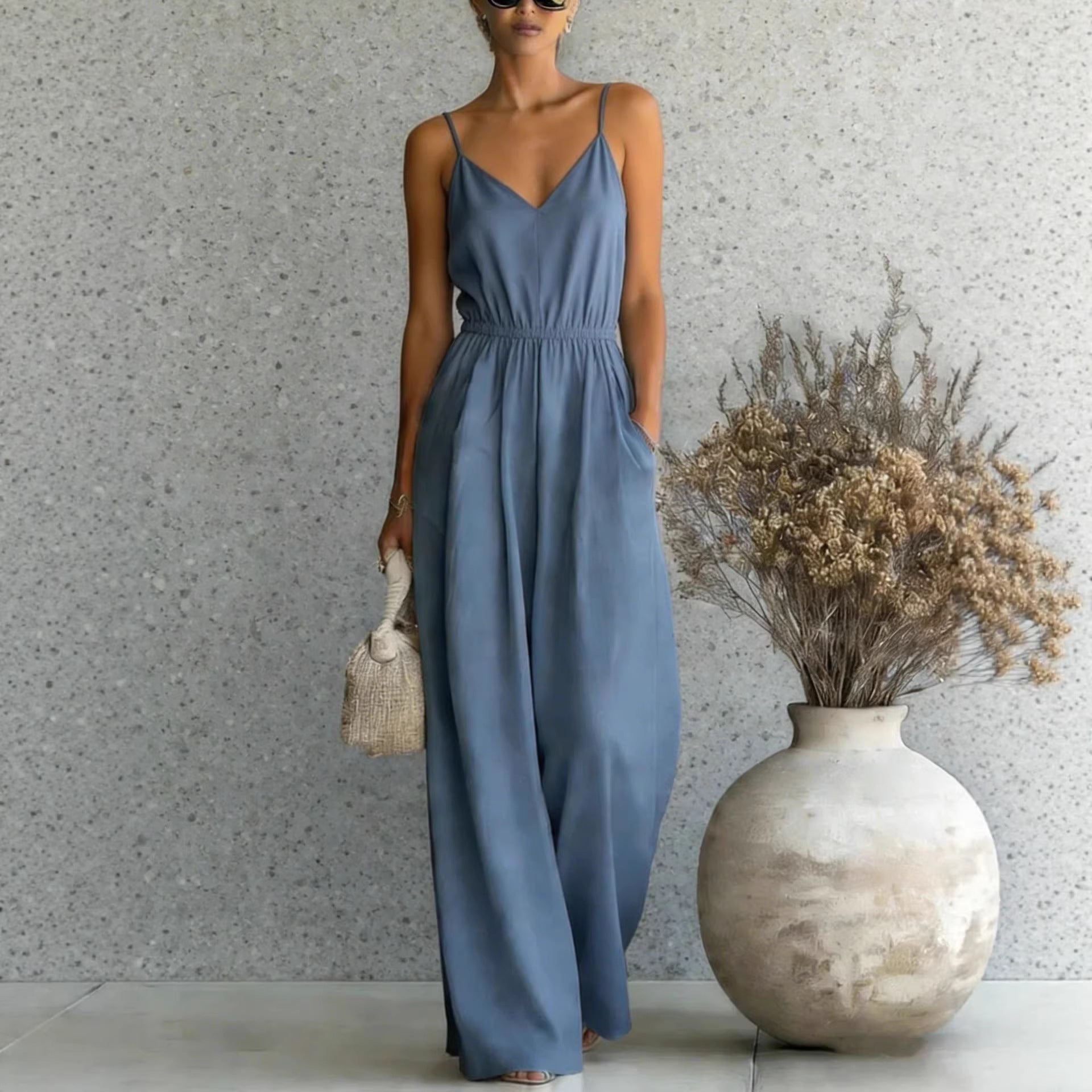 Women's sleeveless wide-leg jumpsuit by FitiqueFit in five colors, shown in a natural pose highlighting the stylish design and fabric.