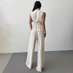 Women's lace-up V-neck vest and pants two-piece set by FitiqueFit, showcasing a stylish, elegant commuter outfit in soft fabric.