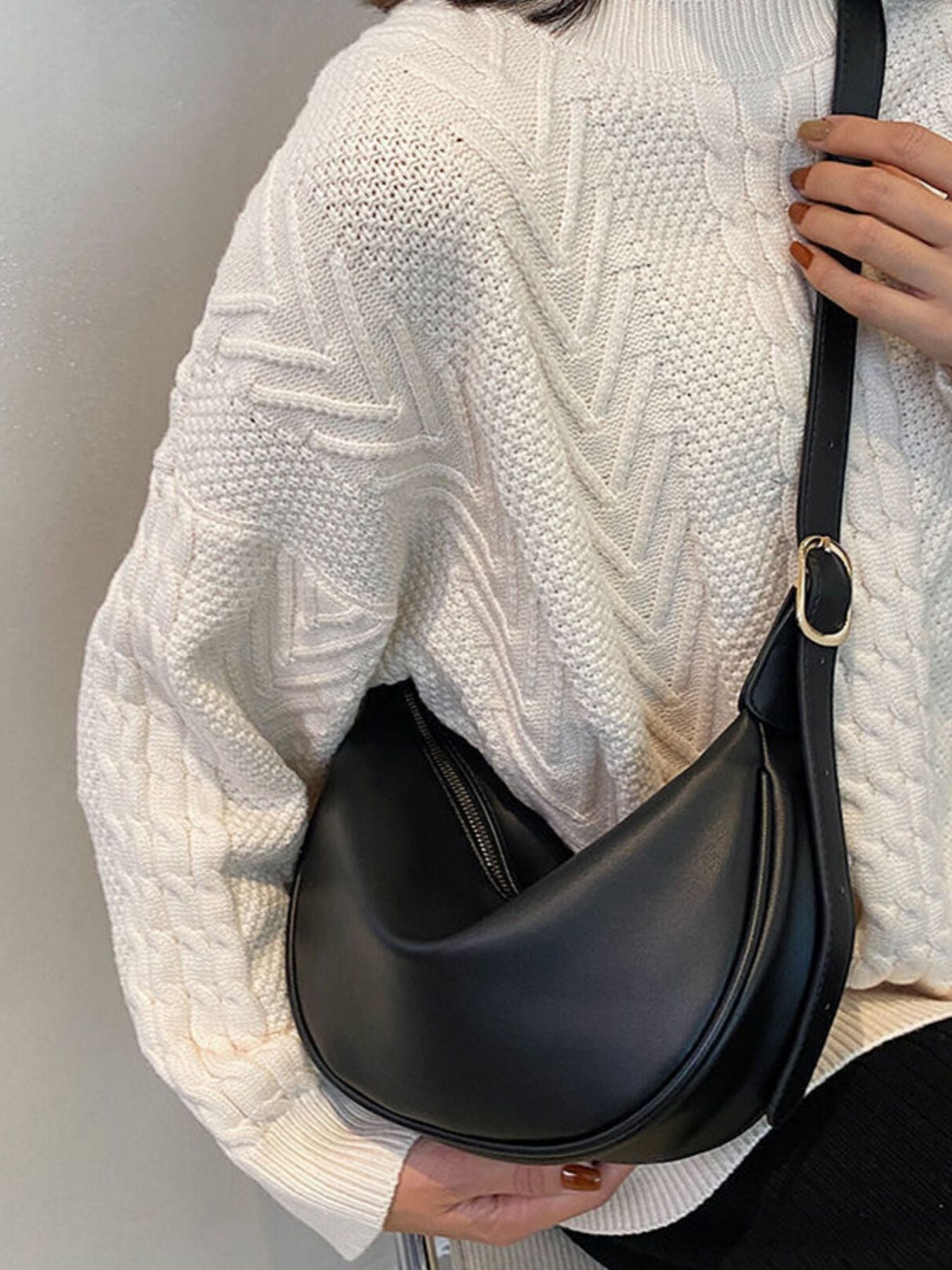 Minimalist crescent-shaped Trendsi crossbody bag in smooth PU leather with shoulder strap, compact and stylish for everyday use.