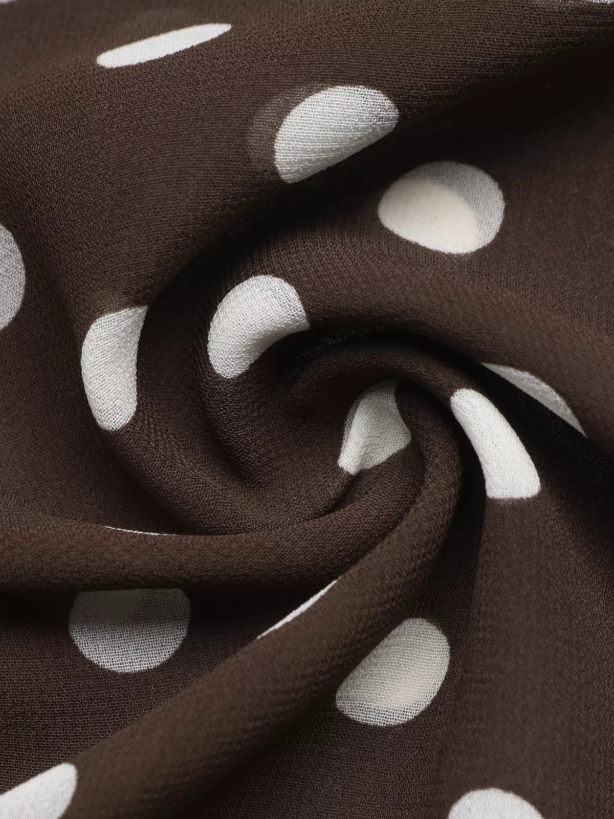 Polka dot mock neck long sleeve blouse from Trendsi, featuring a stylish design with a fitted silhouette and classic pattern.