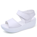 White genuine leather platform sandals with a comfortable wedge sole, open toe, and velcro ankle strap.