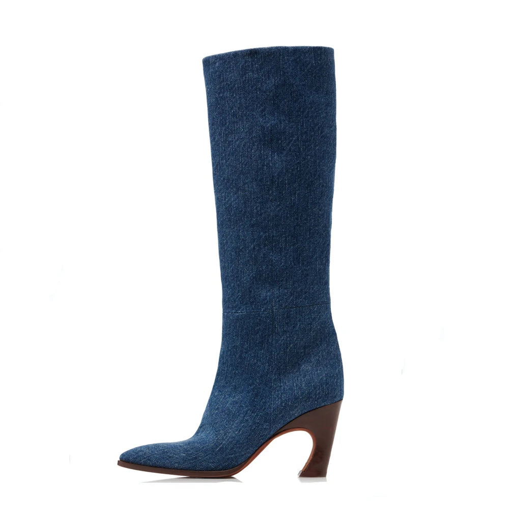 Knee-high denim boot in dark blue with a pointed toe and brown curved heel.