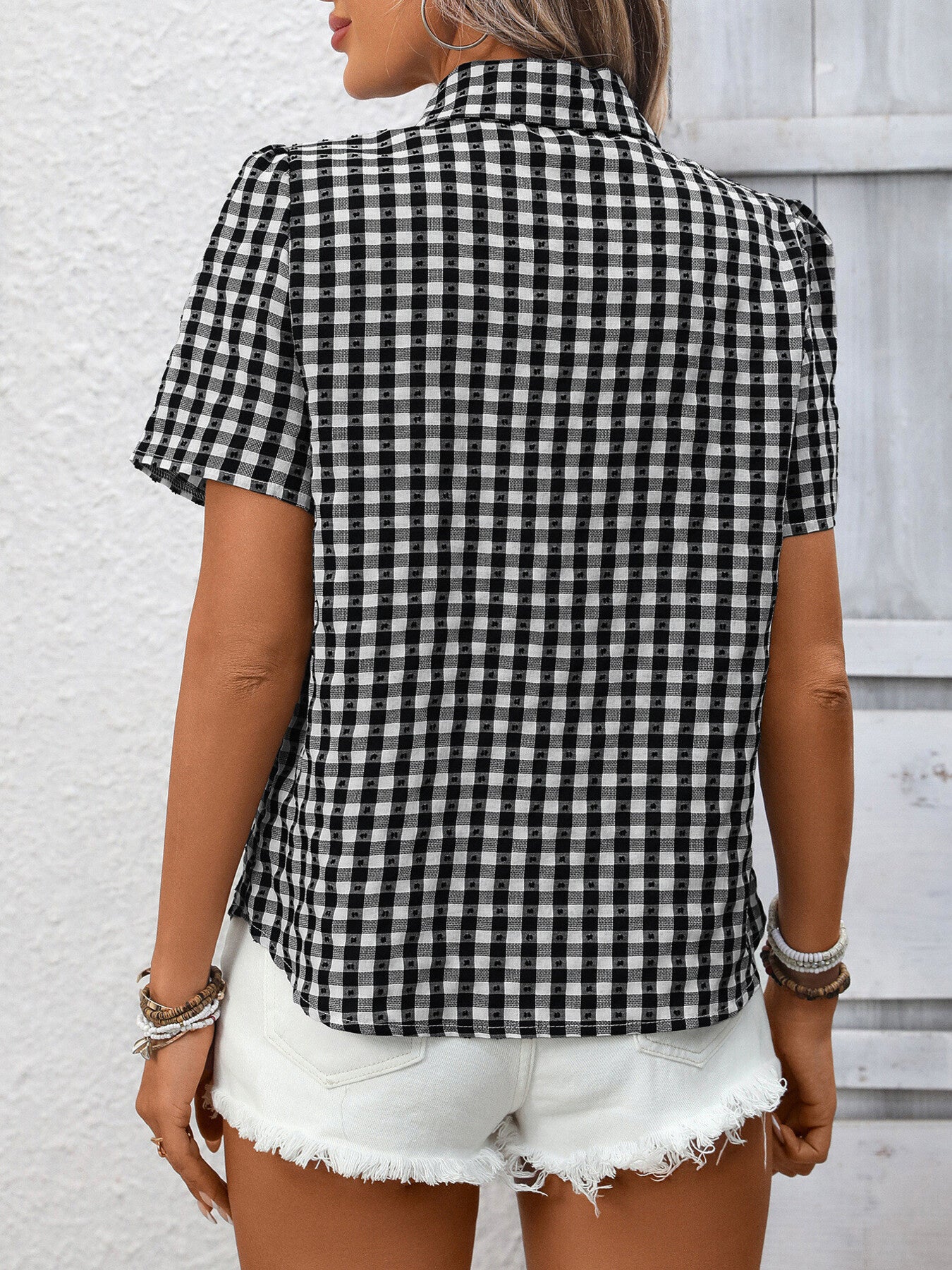 Women's lightweight plaid button-up short sleeve shirt by Trendsi shown in the image with a classic checkered pattern and collar.