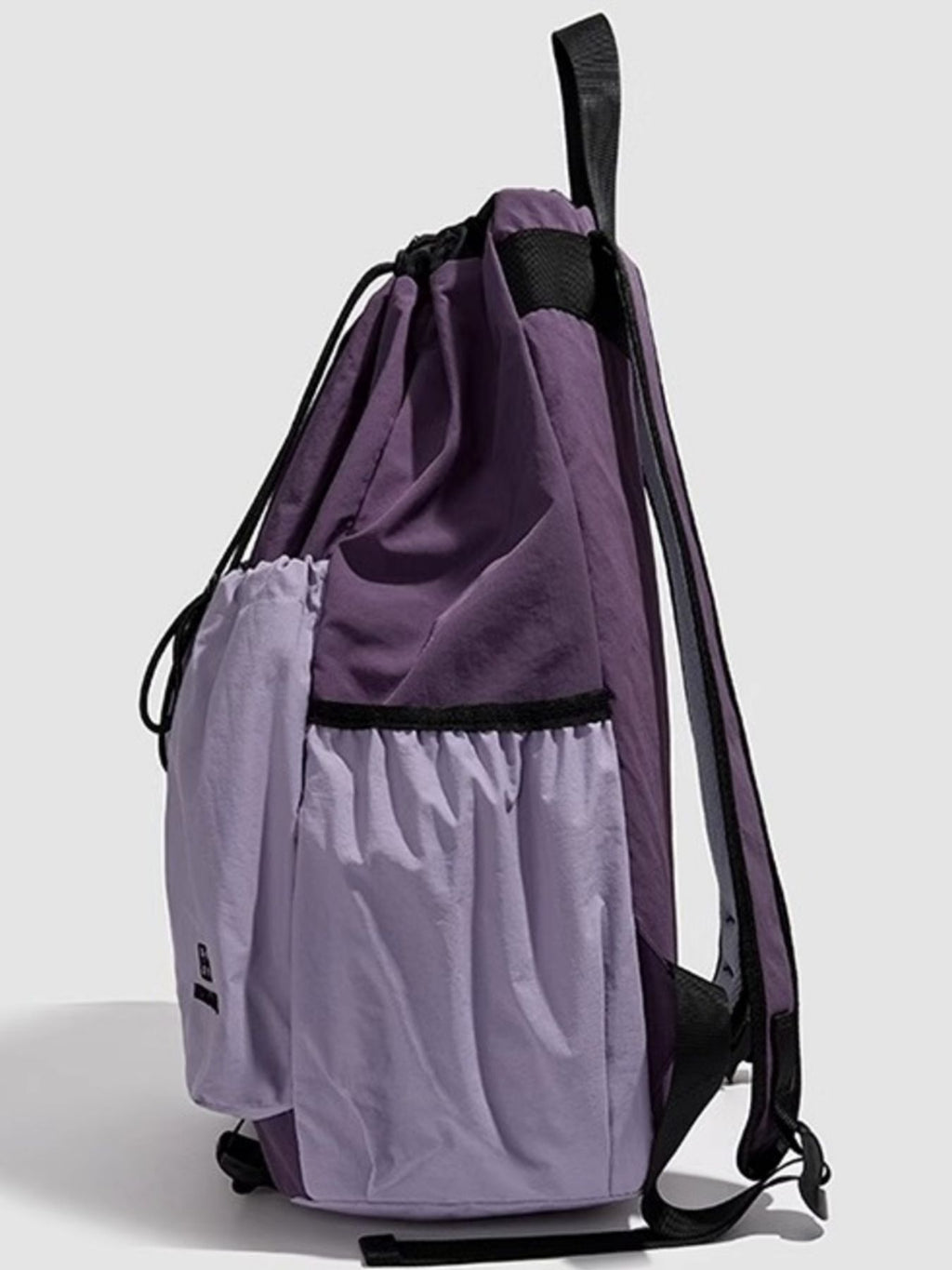 Lightweight nylon drawstring backpack for women, minimalist travel bag with black straps and simple design.