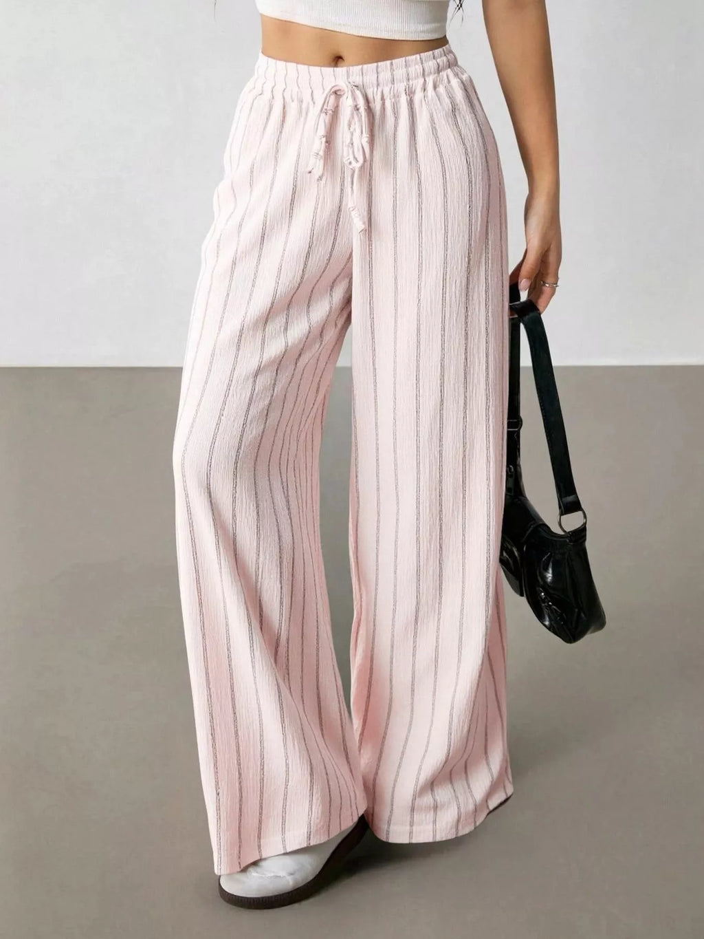 Striped wide-leg drawstring pants from Trendsi featuring a relaxed fit and comfortable waistband, shown on a model.