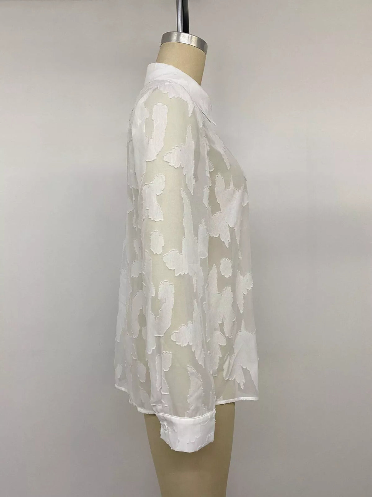 Sheer button-down shirt from Trendsi with long sleeves and classic collar, featuring a lightweight, transparent fabric.