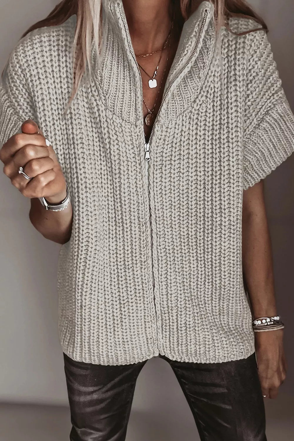 Solid color short sleeve zipper knit high neck sweater from Trendsi, featuring a cozy high neckline and casual style.