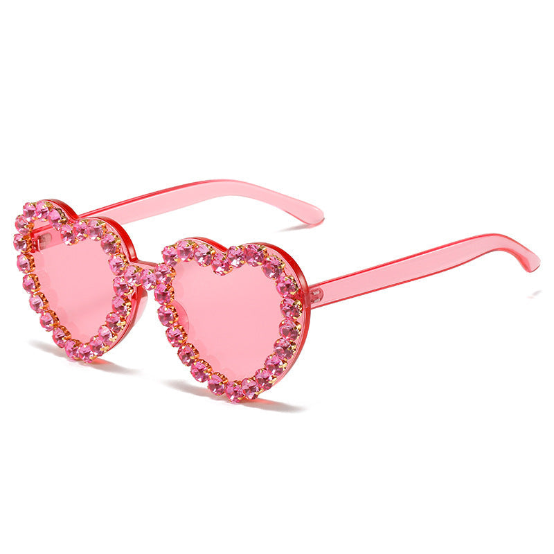 Peach heart-shaped rhinestone sunglasses from Plush Fashion Hub, Y2K INS style, stylish eyewear with rhinestone embellishments.