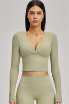 Fitglutes Activewear long sleeve crop top from The Swoon collection, stylish gymwear with a fitted design and long sleeves.