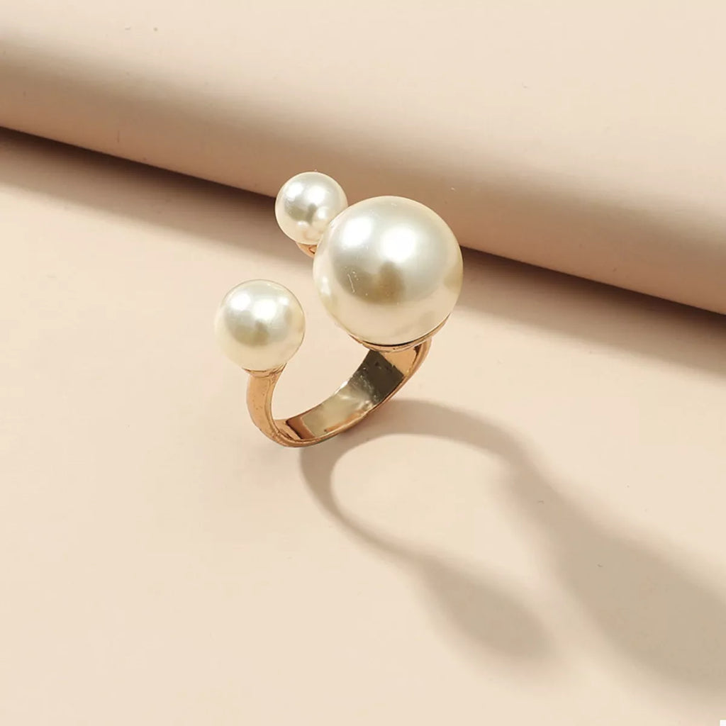 Gold-plated pearl open ring with minimalist design, featuring a shiny pearl centerpiece, crafted by Shopimist.