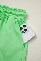 Solid color puffy loose top and drawstring shorts from Trendsi, displayed as a 2-piece outfit with rings on a neutral background.