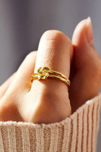 925 sterling silver knotted ring from Shopimist showing a polished silver band with intertwined knot design.