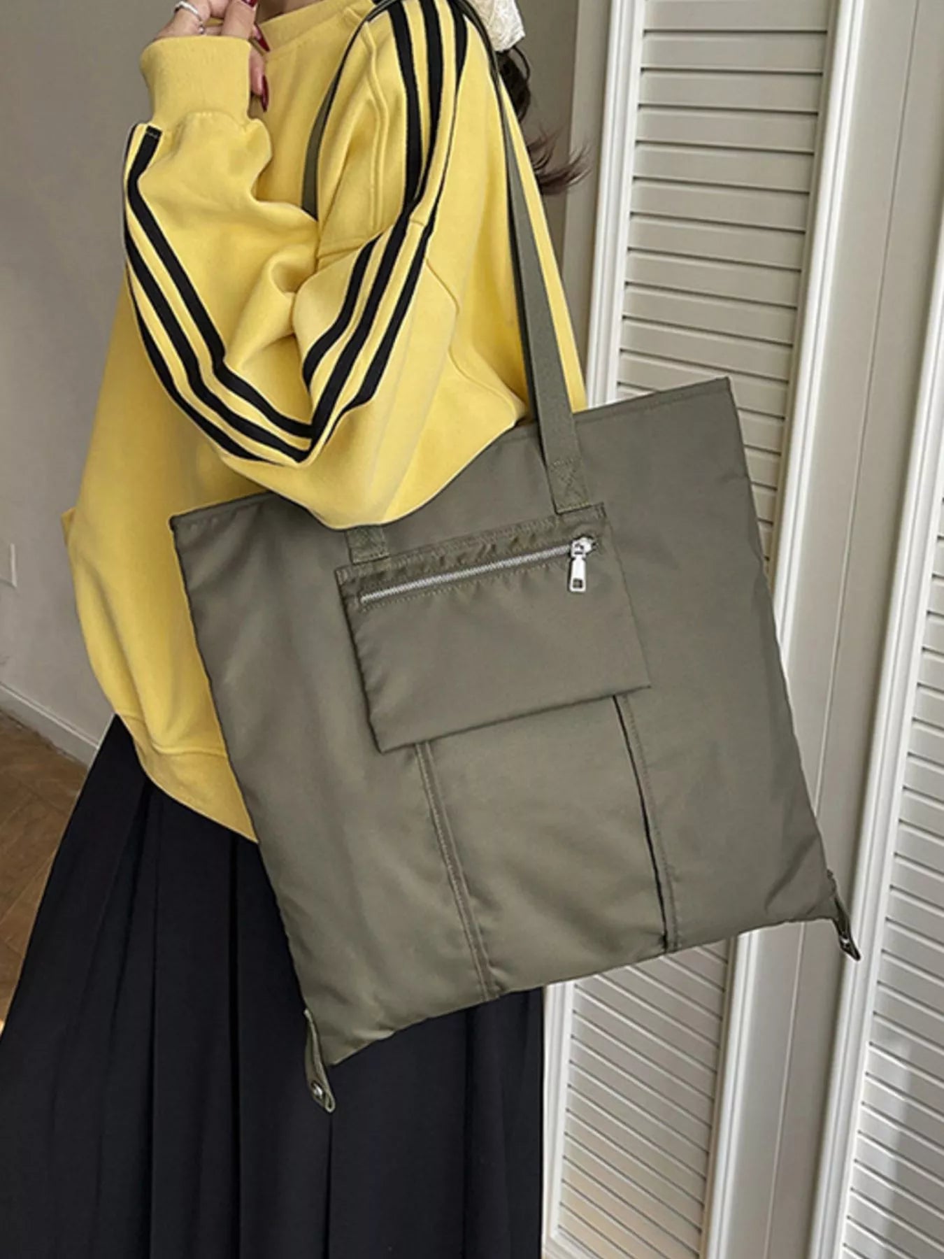 Lightweight nylon shoulder bag from Plush Fashion Hub, casual design with adjustable strap and spacious interior.