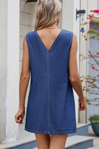 VYSN V-neck sleeveless denim dress hanging on a rack, showcasing casual summer fashion with front pockets and a fitted waist.