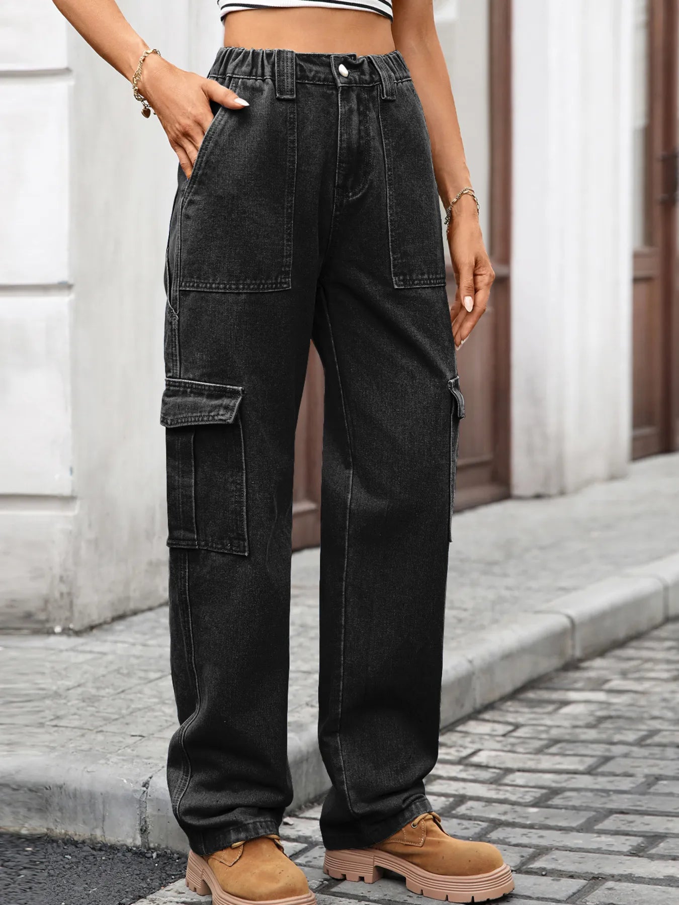 High-waisted plush fashion denim cargo jeans with multiple pockets and relaxed fit, shown on a model against a plain background.