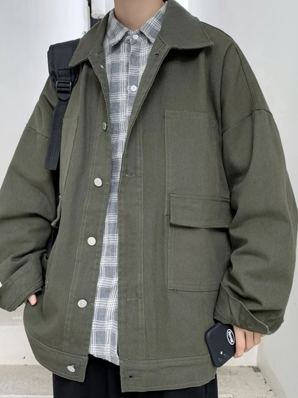 Men's denim jacket with drop shoulder design, button-up front and casual style by Trendsi, shown in a close-up view.