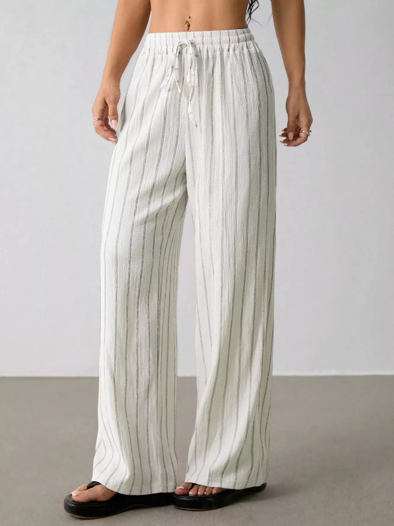 Plush Fashion Hub striped wide-leg drawstring pants made of soft plush fabric, featuring a relaxed fit and comfortable waistband.