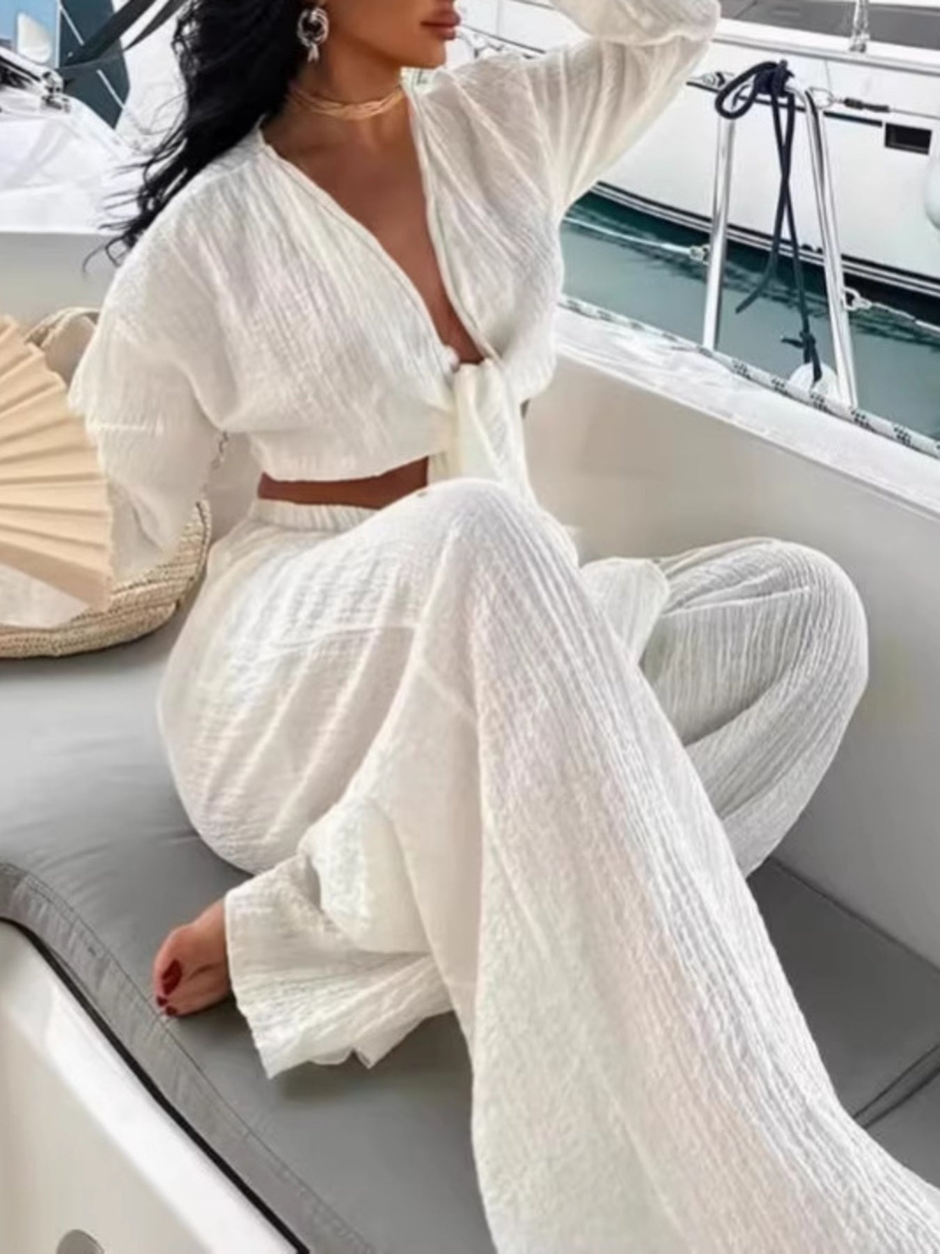 Textured tie-front crop top and wide-leg pants set from Plush Fashion Hub, showcasing the stylish two-piece outfit on a model.