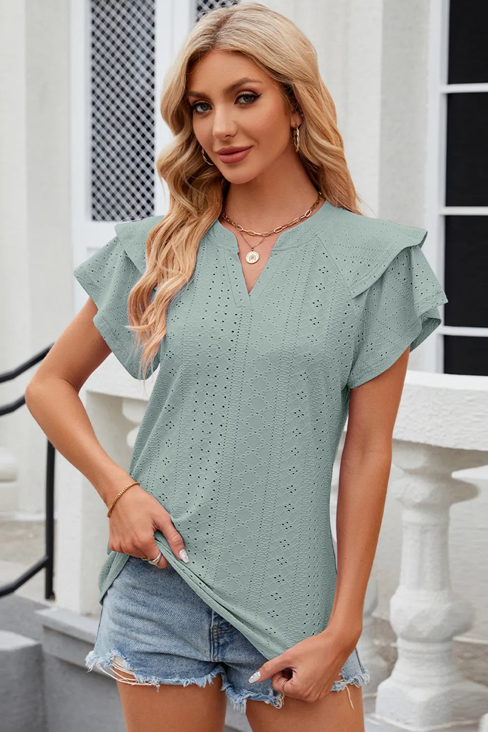 Light blue eyelet notched flutter sleeve T-shirt from Trendsi, featuring a relaxed fit and stylish sleeve design.