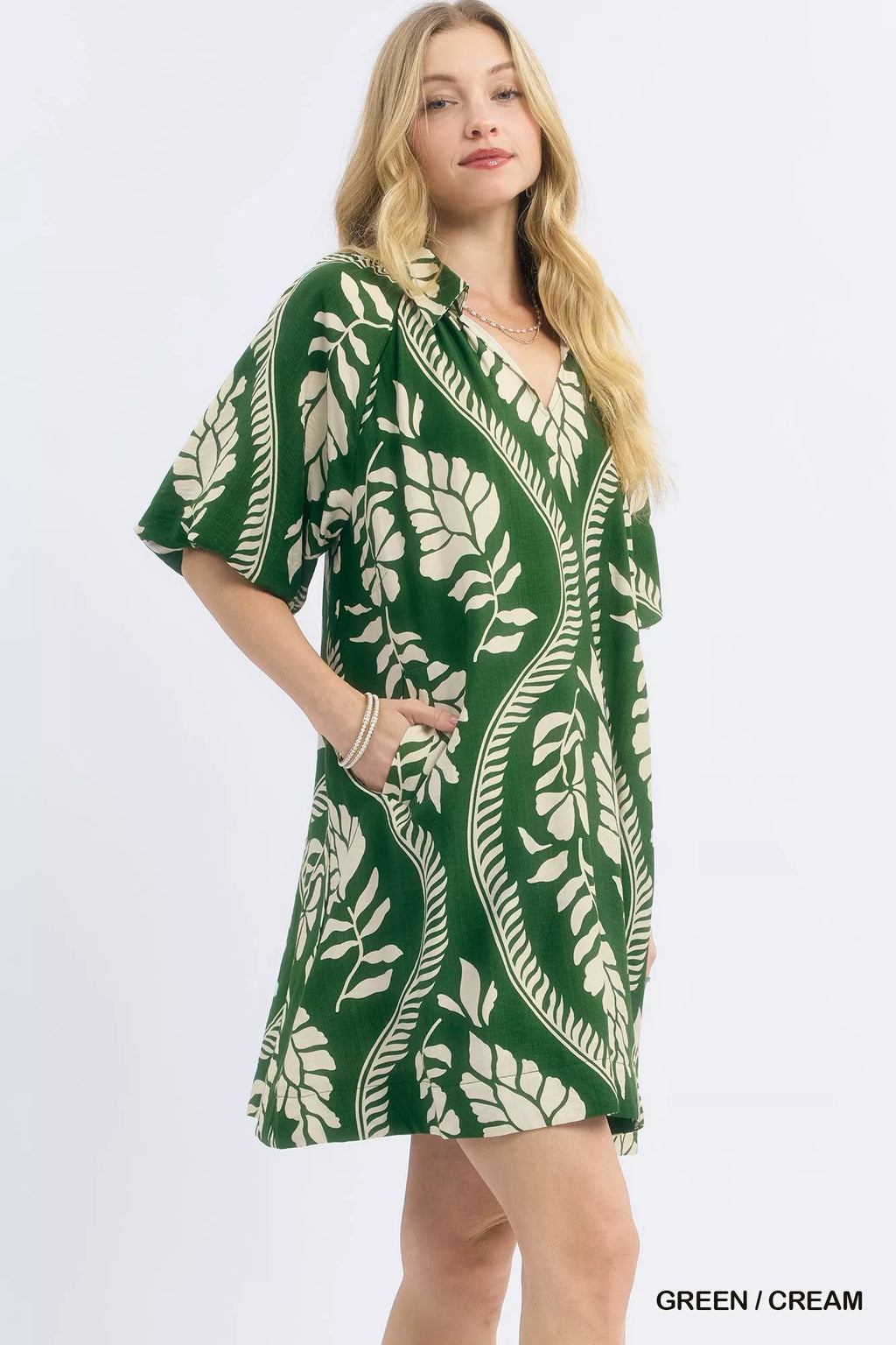 Umgee leafy ogee print mini dress featuring a flowy silhouette and vibrant green leaf pattern, perfect for casual or summer wear.