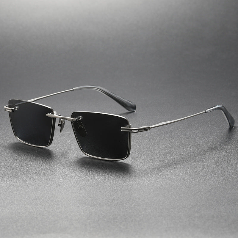 Pure titanium polarized sunglasses in retro British style with dark lenses and slim frame, from Plush Fashion Hub.