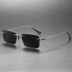 Pure titanium polarized sunglasses in retro British style with dark lenses and slim frame, from Plush Fashion Hub.