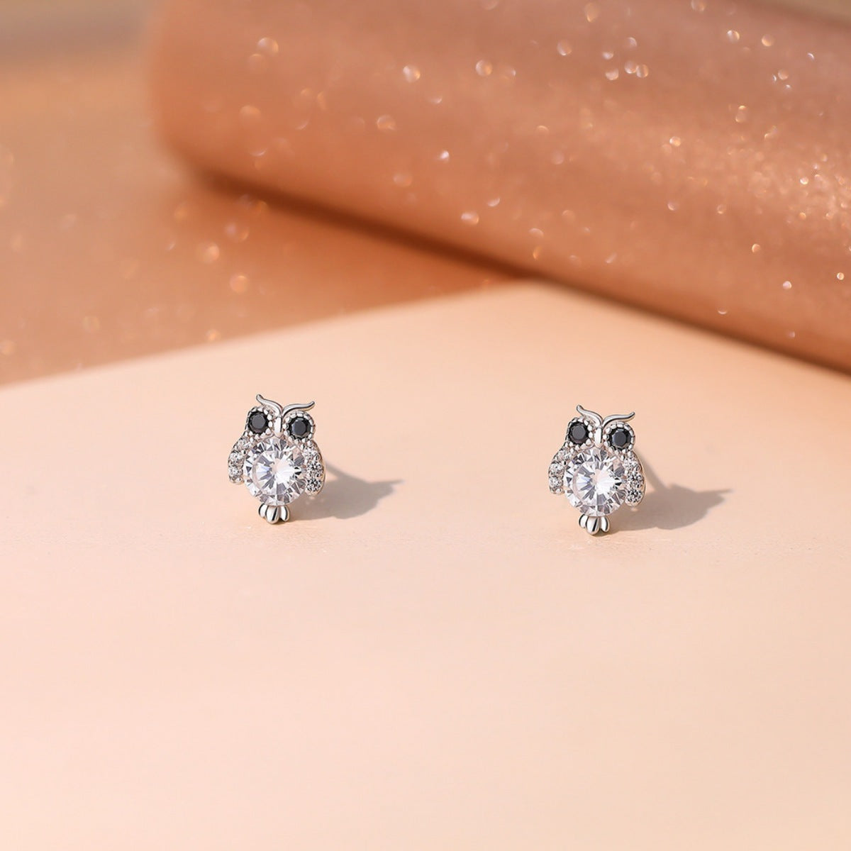 Silver owl stud earrings from Plush Fashion Hub featuring detailed owl face design on a metal stud back.