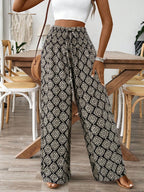 Women's printed wide-leg tie-waist pants from Trendsi, lightweight high-waist trousers with a relaxed fit and stylish pattern.