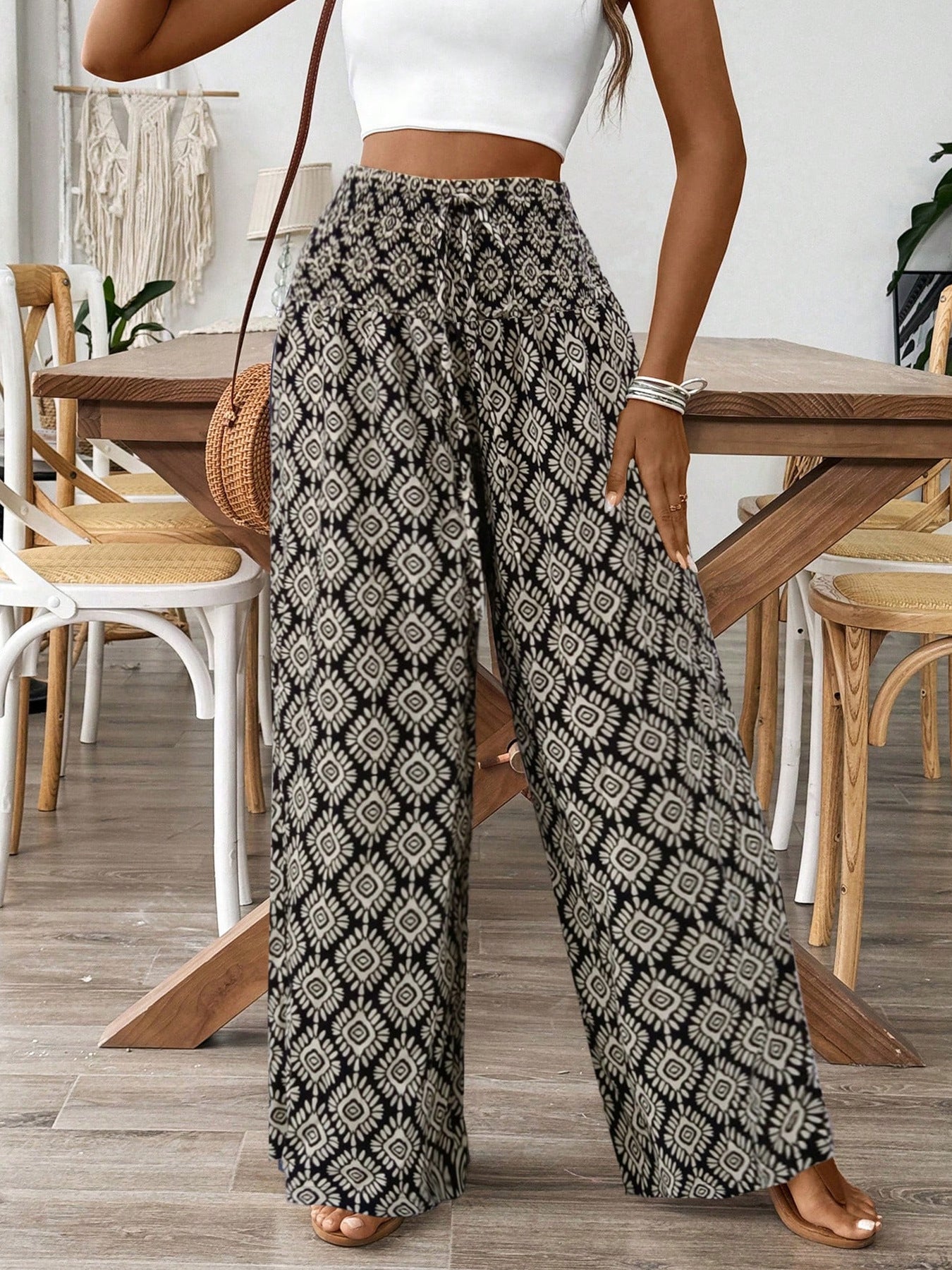 Women's printed wide-leg tie-waist pants from Trendsi, lightweight high-waist trousers with a relaxed fit and stylish pattern.