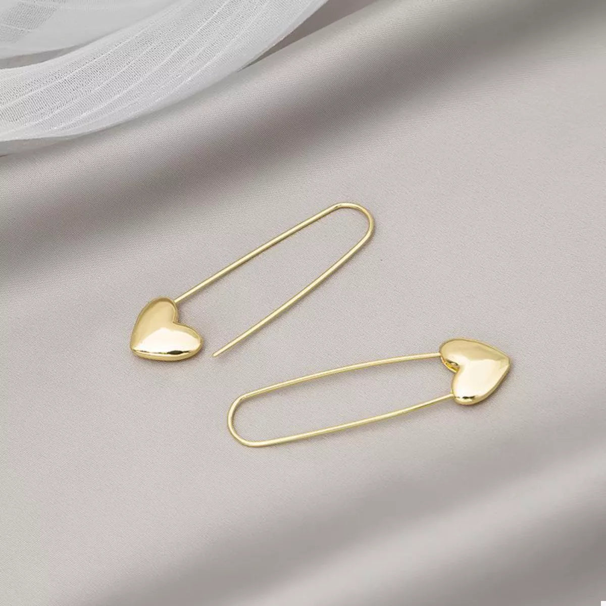 18K gold-plated heart charm safety pin earrings from Plush Fashion Hub featuring a stylish and modern jewelry design.