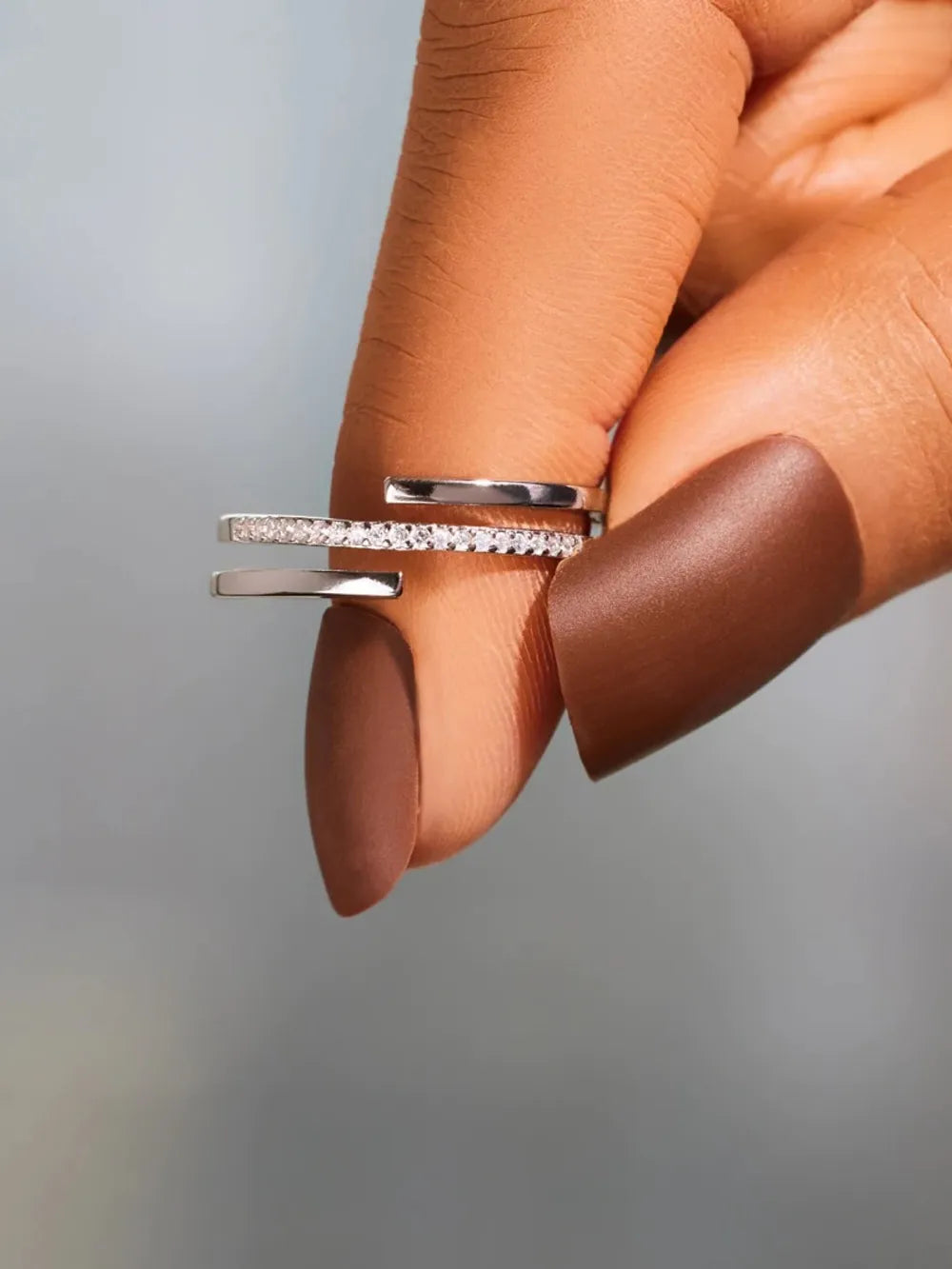 925 Sterling silver ring with inlaid zircon stones, featuring a sleek design and detailed craftsmanship.