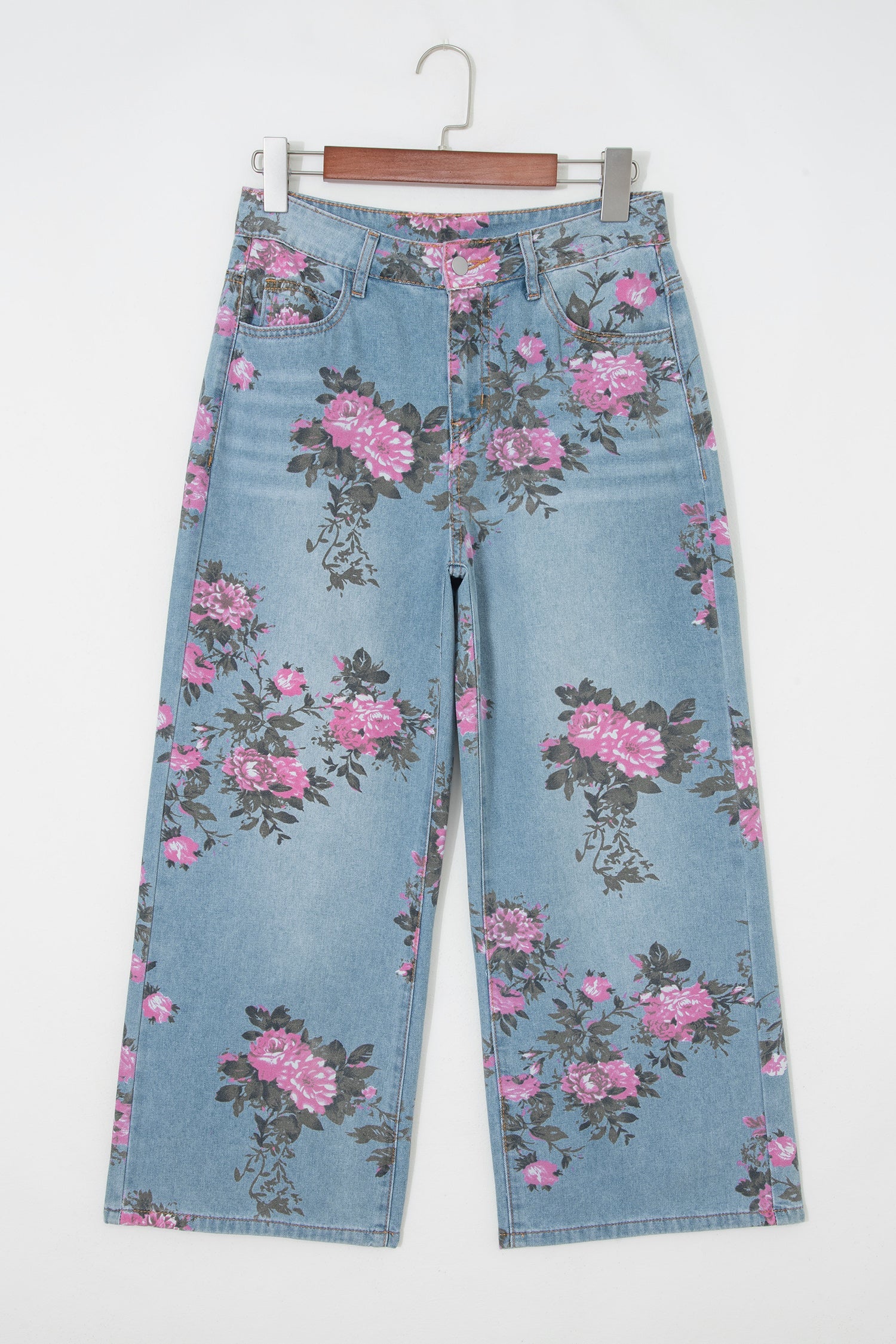 Threaded Pear Esme floral print bootcut jeans with colorful flower pattern and classic denim fit, displayed on a hanger.