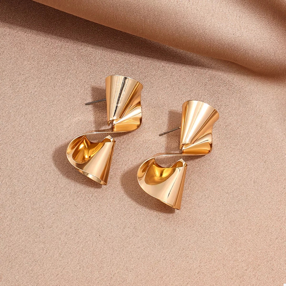 18K gold-plated twist earrings with a sleek, modern design, featuring smooth, intertwined metal curves for elegant style