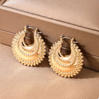 18K gold-plated alloy crescent moon hoop earrings with a sleek, shiny finish, displayed on a white background.