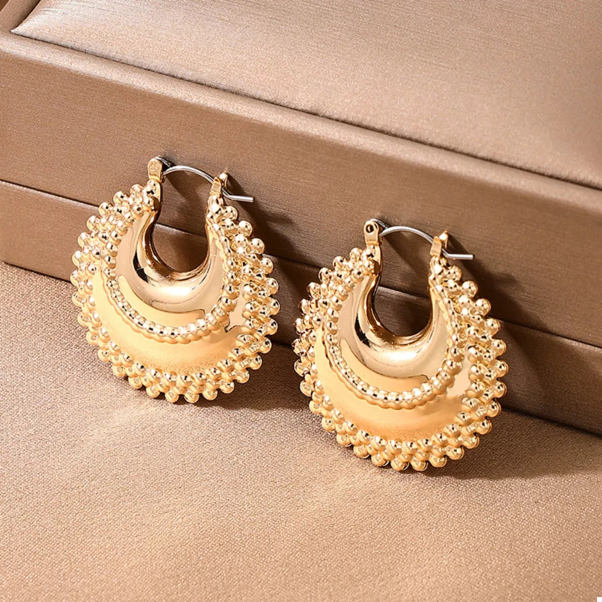 18K gold-plated alloy crescent moon hoop earrings with a sleek, shiny finish, displayed on a white background.