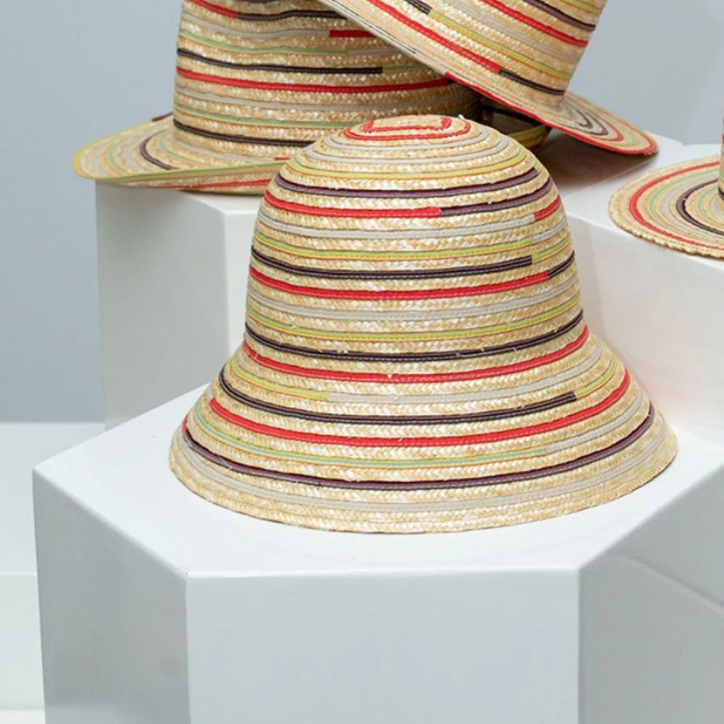 Striped straw bucket hat for women, lightweight summer sun hat with brim, from Plush Fashion Hub, featuring a casual striped design.