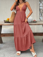 Flowy women's deep V-neck tiered maxi dress by Plush Fashion Hub, featuring smocked boho beach style in lightweight fabric.
