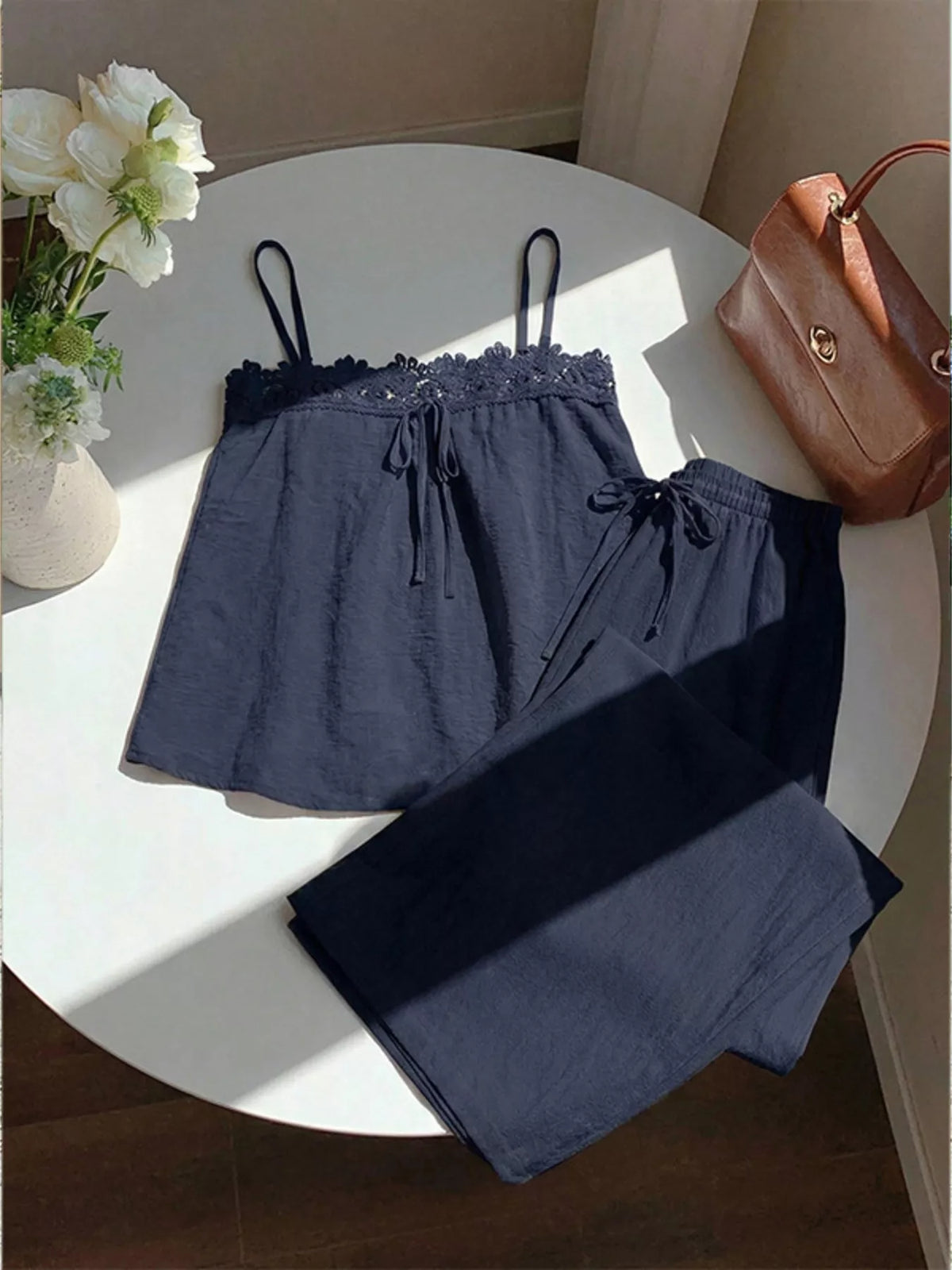 Lace trim cami and wide-leg pants matching set by Plush Fashion Hub, featuring delicate lace details and flowing fabric.