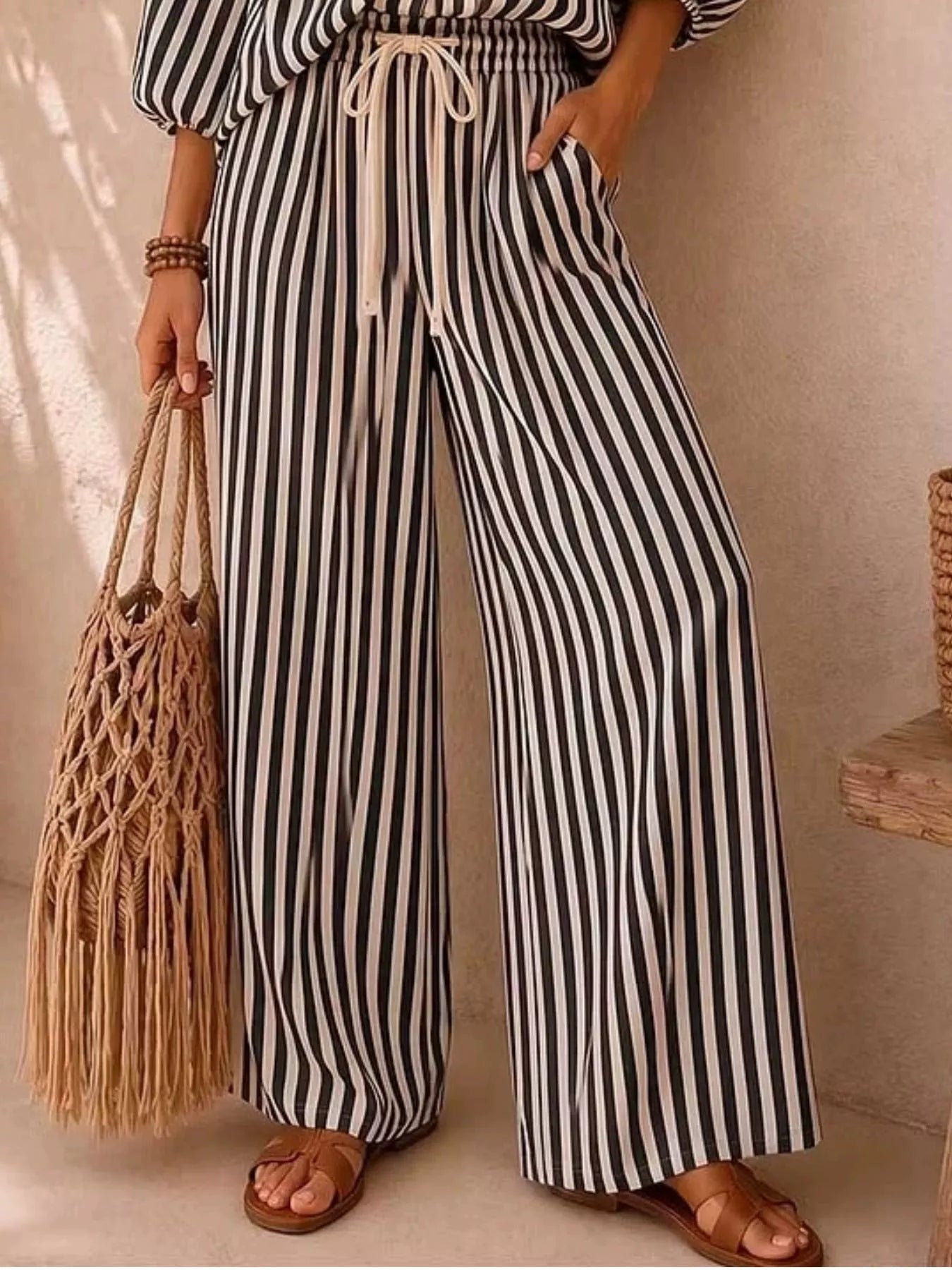 Plus size striped puff sleeve shirt and wide-leg drawstring pants set by Trendsi, featuring a coordinated stylish, comfortable outfit.