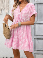 Plush Fashion Hub plaid V-neck mini dress with ruffle hem, lightweight fabric, perfect for seasonal fashion and stylish occasions.