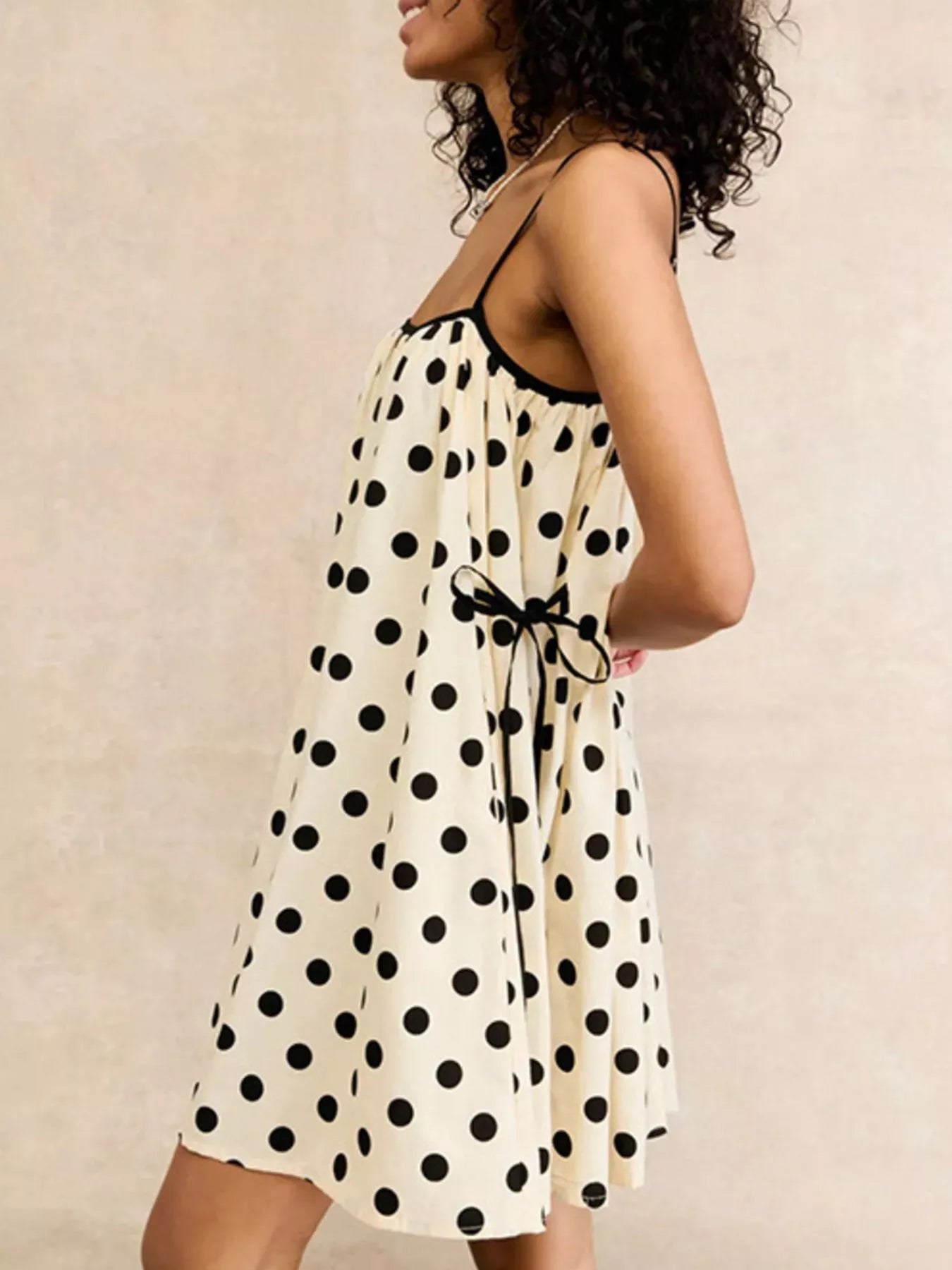 Polka dot spaghetti strap mini dress by Plush Fashion Hub featuring a fitted silhouette and playful pattern.