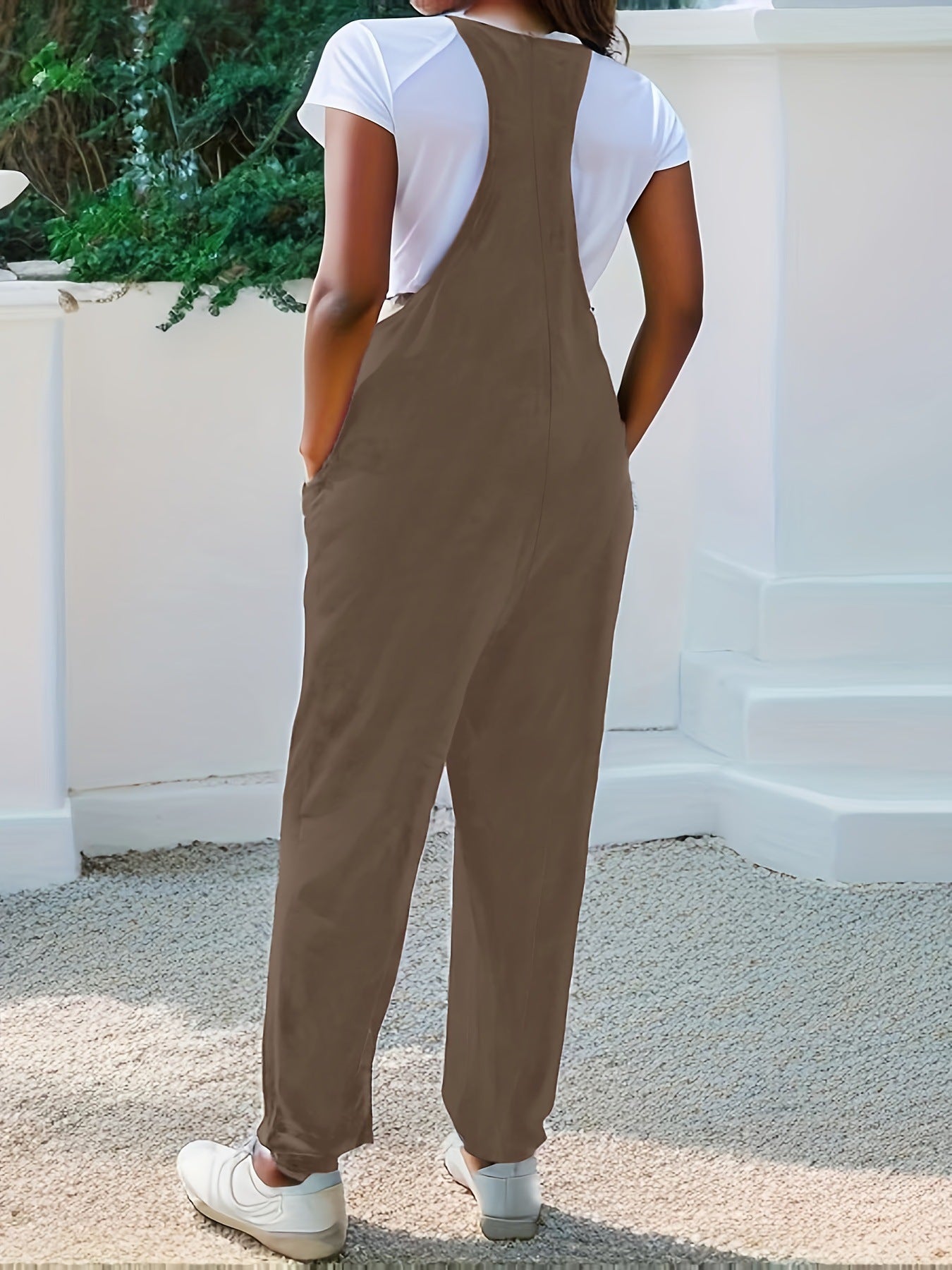 Casual loose fit spaghetti strap jumpsuit with pockets, black Trendsi jumpsuit worn by a model outdoors.