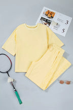 Plush Fashion Hub rings set featuring a half sleeve top and drawstring pants, with decorative ring accents on the fabric.