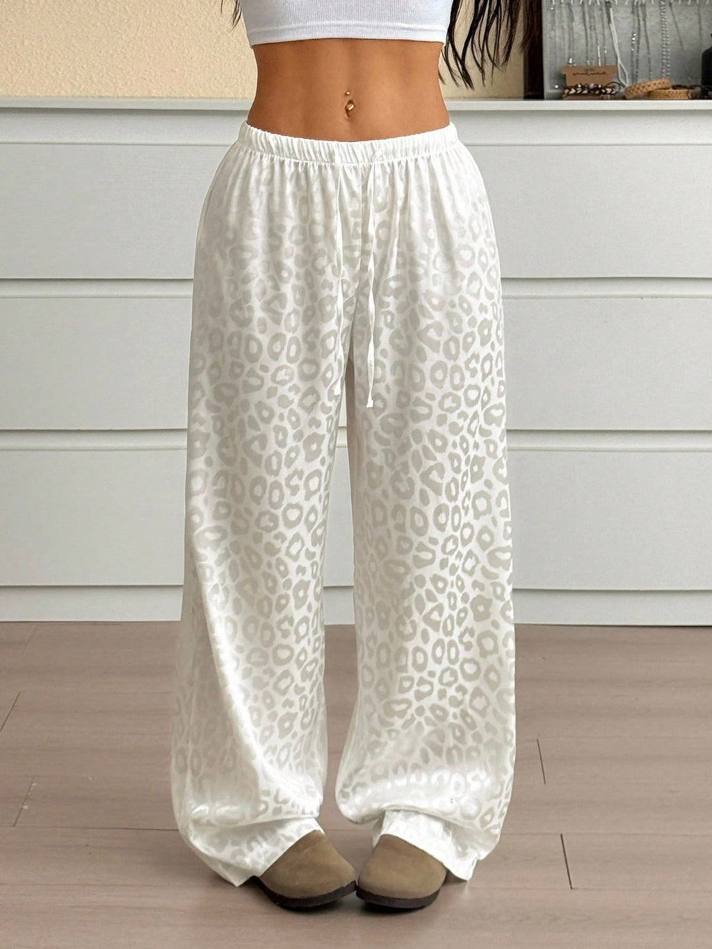 Women's leopard print wide leg trousers with adjustable drawstring waist from Trendsi, featuring a relaxed fit and stylish pattern.