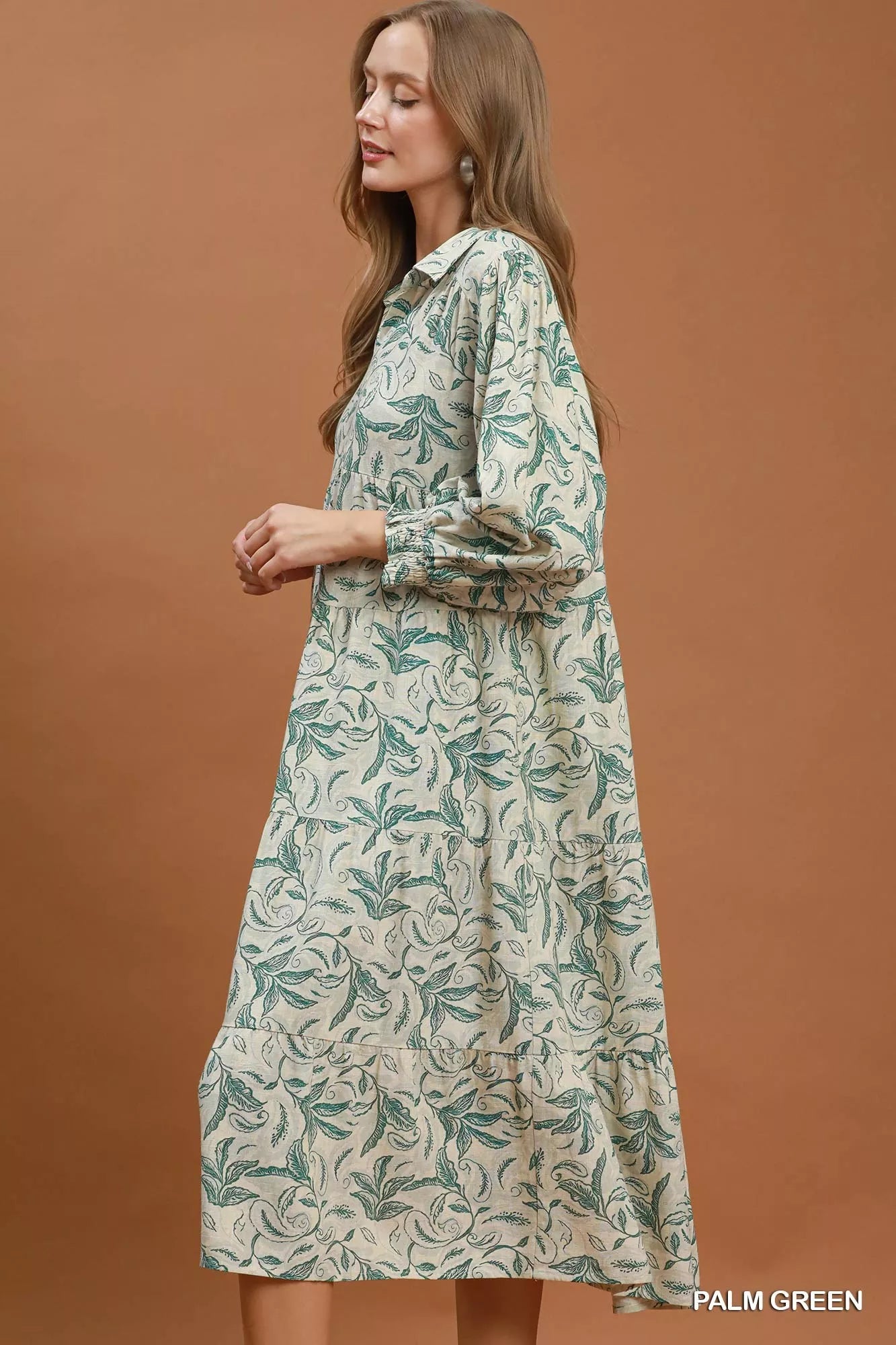 Umgee Linen Botanical Print Tiered Midi Dress displayed on model, showcasing its flowy silhouette and floral pattern.