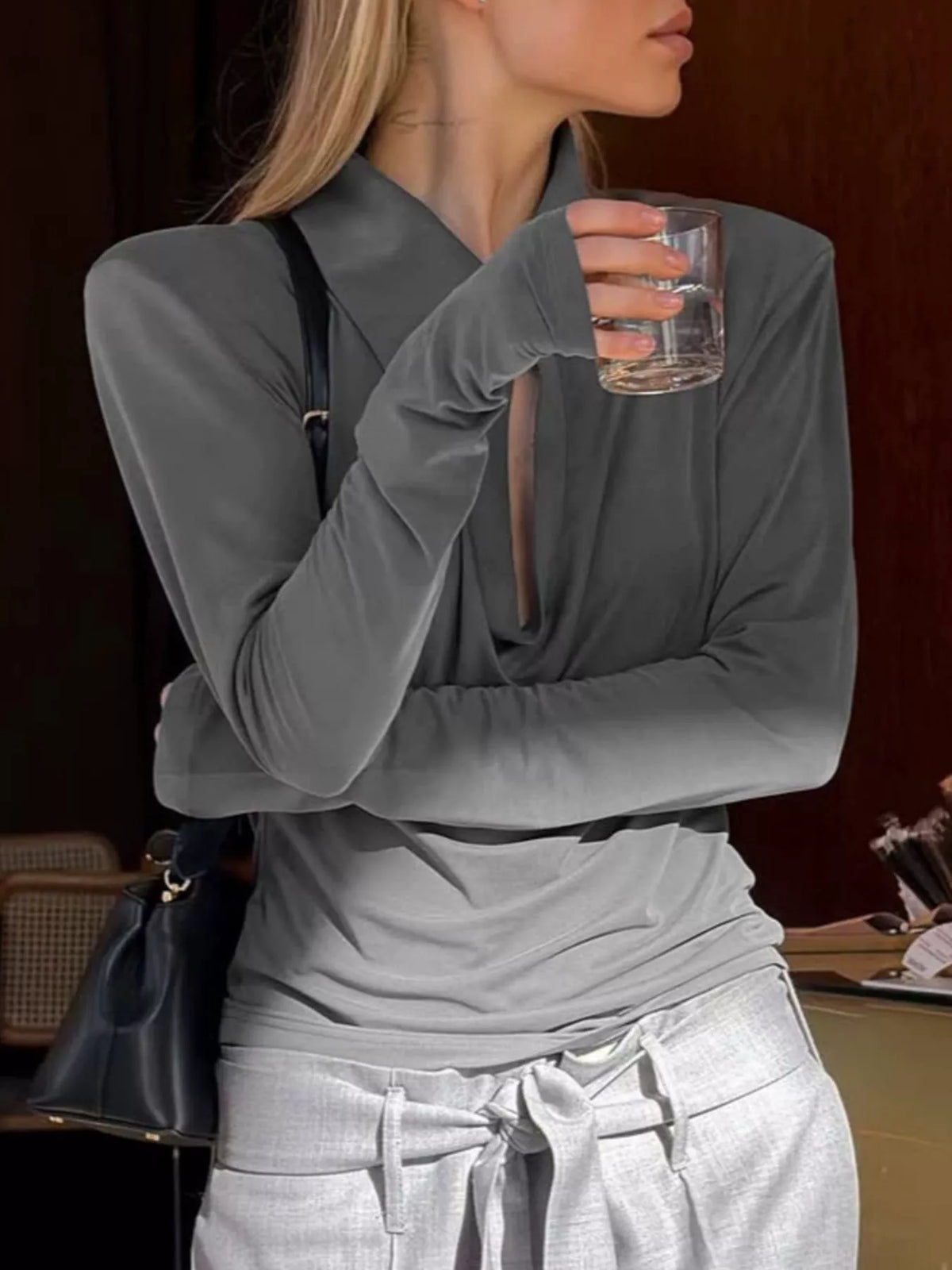 Long-sleeve slim-fit T-shirt by Trendsi with stylish cutout detail on the chest, made from soft, comfortable fabric.