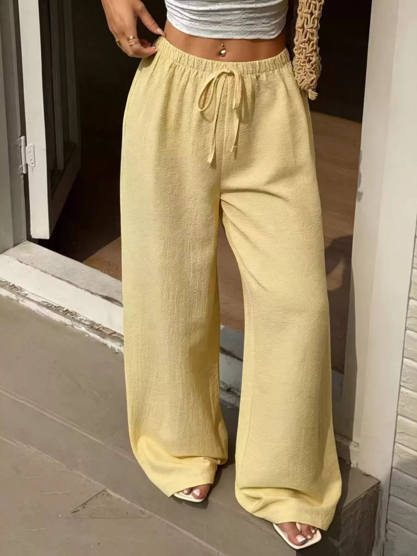 Plus size high-waisted wide-leg pants from Plush Fashion Hub, shown in black with a relaxed fit and flowing fabric.