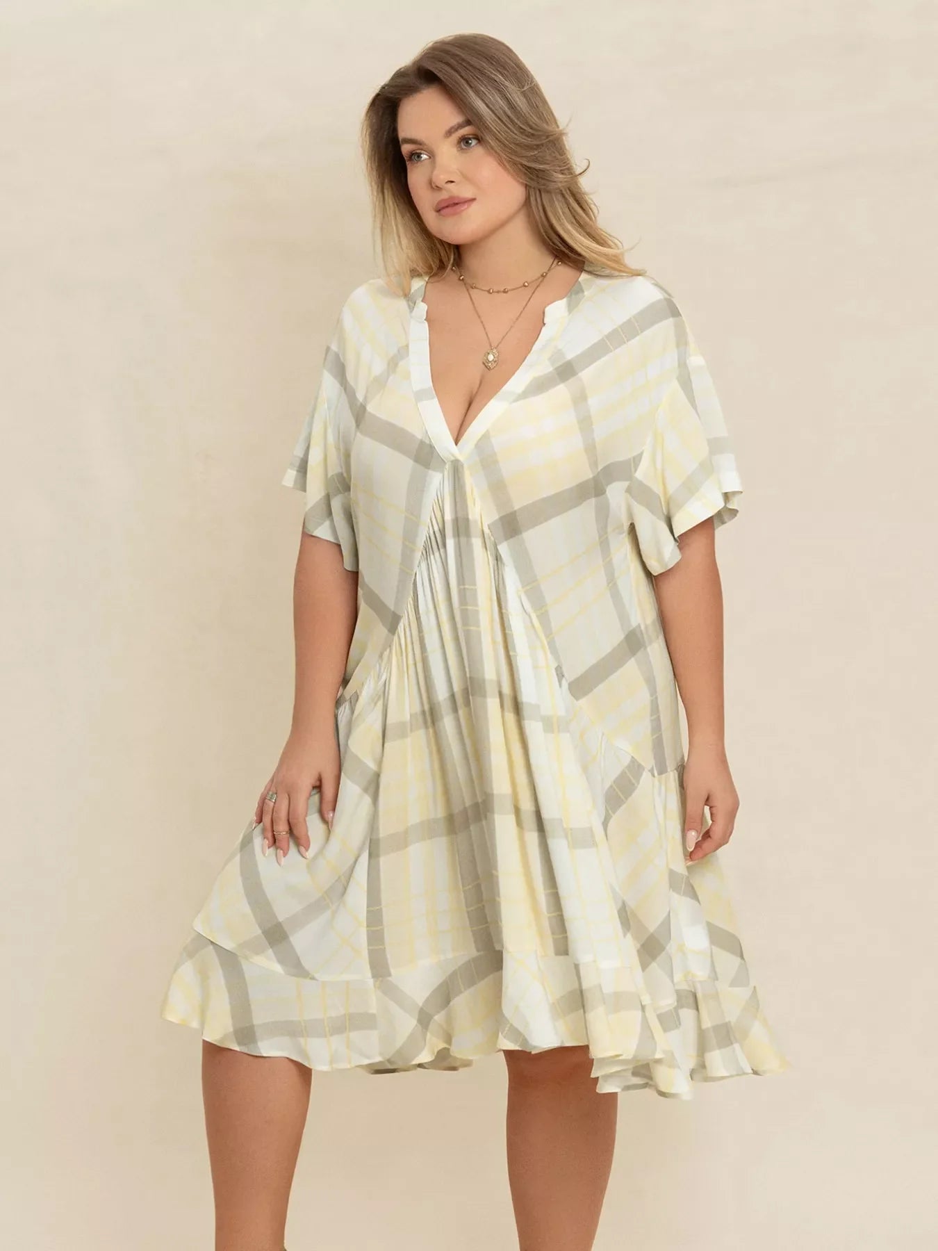 Plus size plaid flutter sleeve dress by Shopimist featuring a flowy design and stylish plaid pattern.