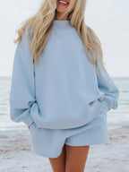 Plush Fashion Hub relaxed fit round neck sweatshirt and matching shorts set, casual 2-piece loungewear on a model.