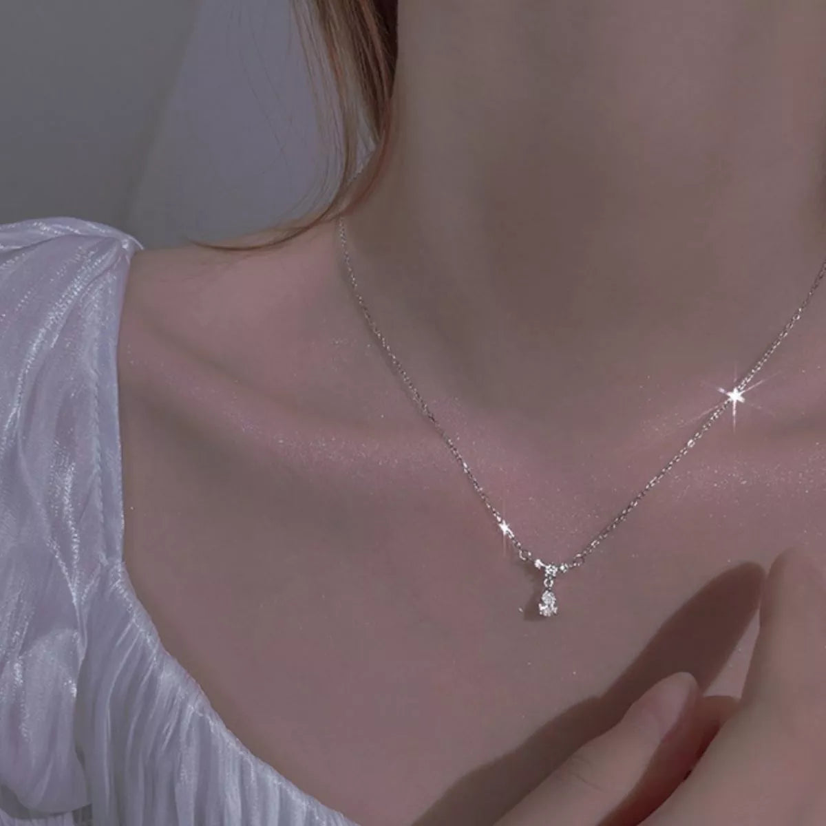 Sterling silver zircon teardrop necklace with a delicate chain and sparkling gemstone, showcasing elegant jewelry design.